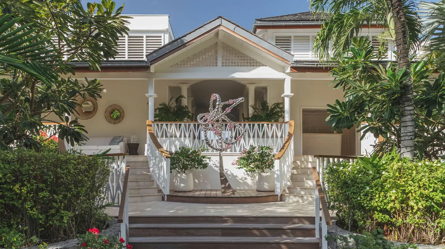 Cheval Blanc St-Barth entrance with lush greenery and a statement sculpture in St. Barts