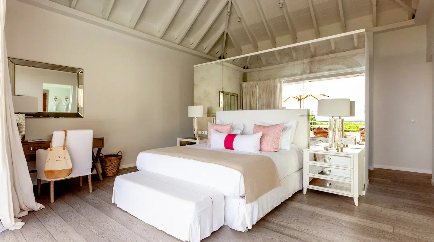 Elegant bedroom at Hôtel Le Toiny in St. Barts with a stylish, modern interior.