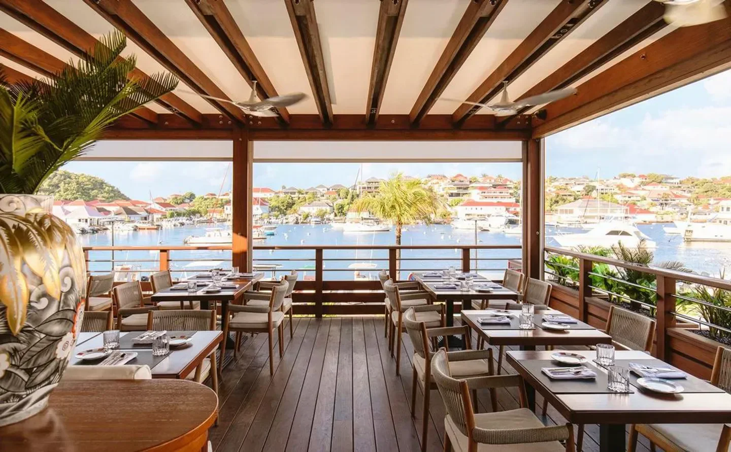 Outdoor dining at L'Atelier de Joel Robuchon in St. Barts with harbor view