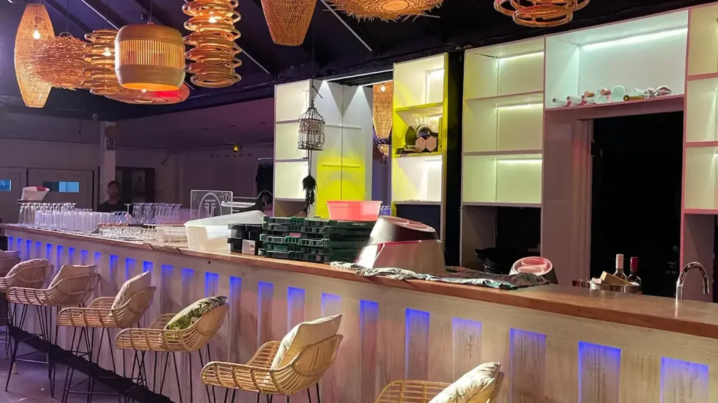 Interior bar at Modjo nightclub in St. Barts, featuring stylish rattan bar stools.