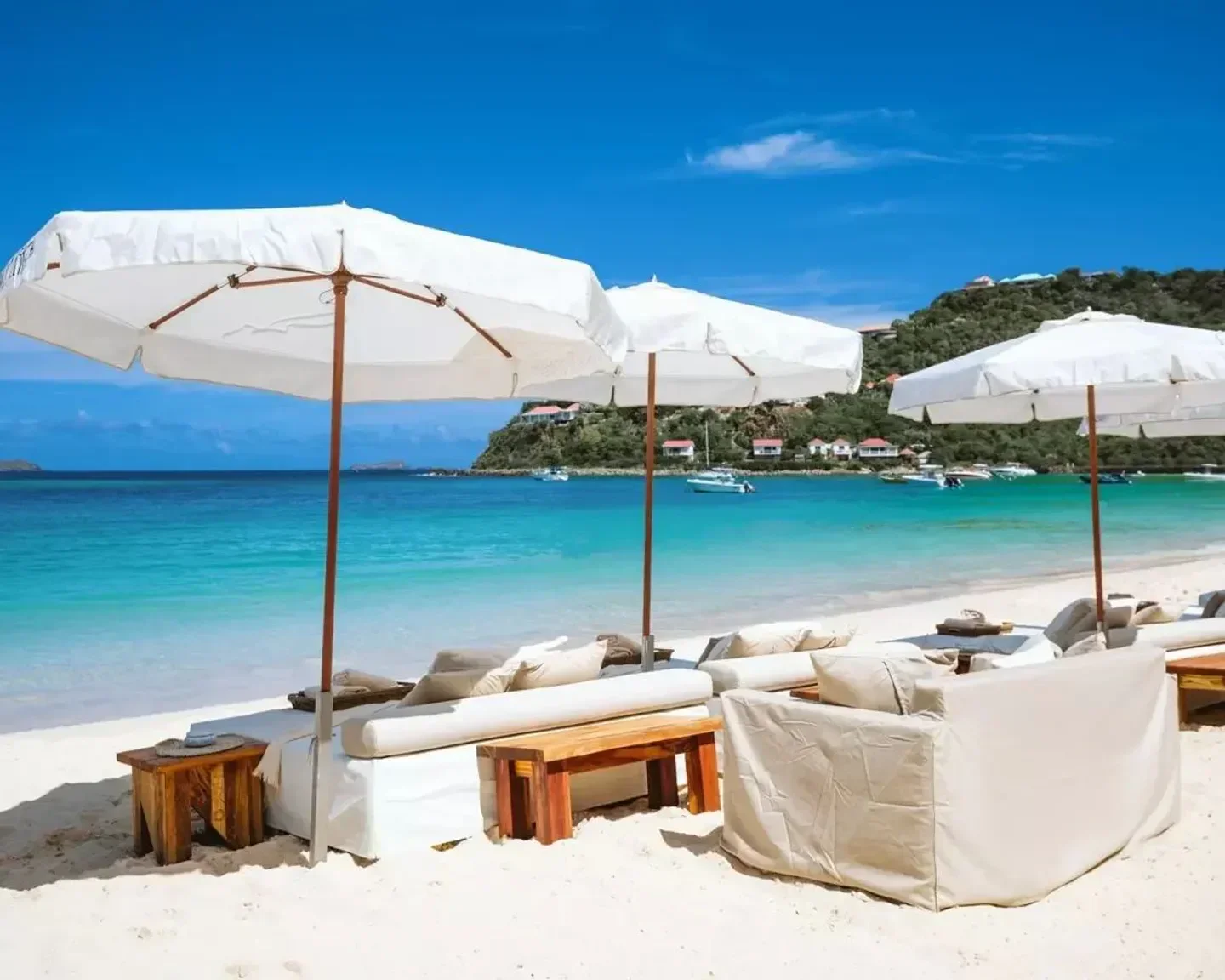 Beachfront scene at Nikki Beach St. Barts with lounge chairs and umbrellas under the sun.