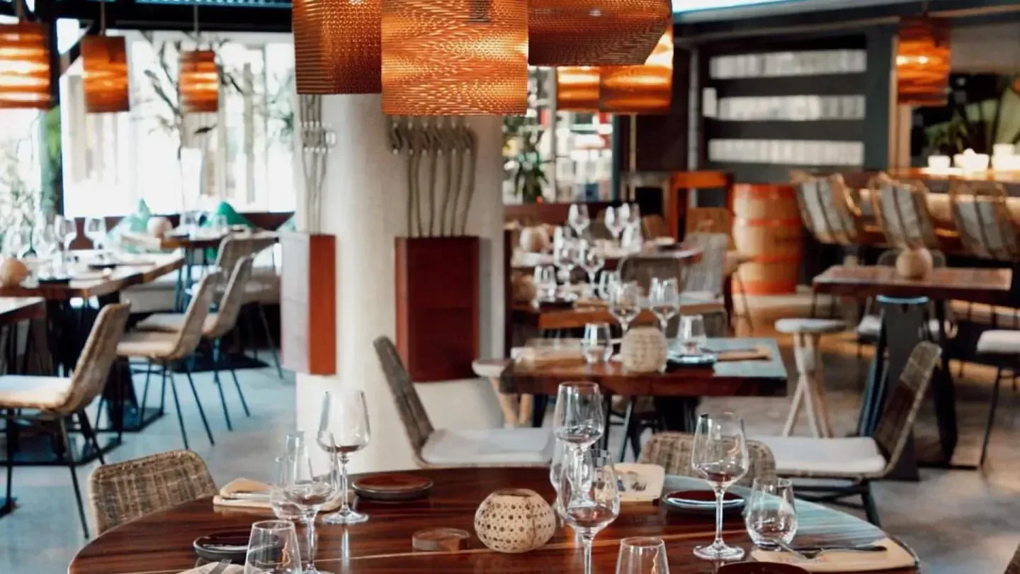 Interior of Zion restaurant in St. Barts, showcasing elegant dining with woven chairs